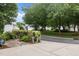 Landscaped front yard featuring mature trees and walkway leading to well-maintained townhomes at 3902 Stags Leap Cir, Raleigh, NC 27612
