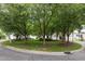 Well-maintained front lawn with mature trees providing shade and enhancing curb appeal for the property at 3902 Stags Leap Cir, Raleigh, NC 27612