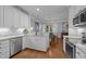 Well-designed kitchen with white cabinets, granite countertops, and stainless steel appliances at 3902 Stags Leap Cir, Raleigh, NC 27612