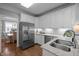 Bright kitchen with stainless steel appliances, granite countertops, and white cabinets at 3902 Stags Leap Cir, Raleigh, NC 27612