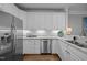 Stylish kitchen featuring stainless steel appliances, granite countertops, and white cabinets at 3902 Stags Leap Cir, Raleigh, NC 27612