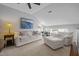 Spacious living room with vaulted ceiling, carpet, white furniture, and modern decor at 3902 Stags Leap Cir, Raleigh, NC 27612