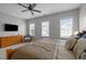 Spacious main bedroom featuring three windows with blinds, dresser, ceiling fan, and soft, neutral tones at 3902 Stags Leap Cir, Raleigh, NC 27612
