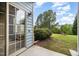 Back patio with glass door entry to back yard and lawn at 404 Panorama Park Pl, Cary, NC 27519