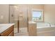Bright bathroom featuring a glass shower, soaking tub, and a window with natural light at 404 Panorama Park Pl, Cary, NC 27519