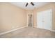 Cozy bedroom with neutral carpet and paint, a ceiling fan, and double closets at 404 Panorama Park Pl, Cary, NC 27519