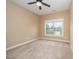 Cozy bedroom with neutral carpet and paint, a ceiling fan, and a bright window at 404 Panorama Park Pl, Cary, NC 27519