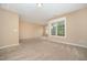 Bright bedroom features neutral carpet, paint, and trim and large windows at 404 Panorama Park Pl, Cary, NC 27519