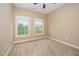 Bright bedroom with neutral carpeting and two windows providing plenty of natural light at 404 Panorama Park Pl, Cary, NC 27519