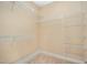 Spacious walk-in closet featuring neutral carpeting and white shelving units for ample storage at 404 Panorama Park Pl, Cary, NC 27519