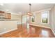 Bright dining area featuring hardwood floors, large windows, and modern light fixture at 404 Panorama Park Pl, Cary, NC 27519