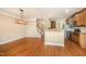 Open-concept dining area with hardwood floors connecting to the kitchen and stairway at 404 Panorama Park Pl, Cary, NC 27519