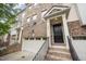 Inviting entrance to brick townhome with black front door and railed stairway at 404 Panorama Park Pl, Cary, NC 27519