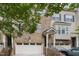 Close-up of brick townhome with attached garage and front entryway with stairs at 404 Panorama Park Pl, Cary, NC 27519