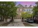 Charming townhome exterior featuring a brick facade, attached garages, and well-maintained landscaping at 404 Panorama Park Pl, Cary, NC 27519