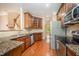 Kitchen with granite counters, stainless appliances, and dark wood cabinets at 404 Panorama Park Pl, Cary, NC 27519