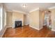 Bright living room featuring a cozy fireplace, hardwood floors, and neutral wall paint at 404 Panorama Park Pl, Cary, NC 27519