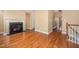 Bright living room featuring a cozy fireplace, hardwood floors, and neutral wall paint at 404 Panorama Park Pl, Cary, NC 27519