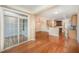 Bright living area featuring hardwood floors, sliding door, and kitchen view at 404 Panorama Park Pl, Cary, NC 27519