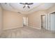 Spacious main bedroom with tray ceiling, ceiling fan, and carpeted floors at 404 Panorama Park Pl, Cary, NC 27519