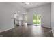 Open-concept living area with wood-look floors and sliding glass doors to backyard at 405 Benton Dr, Oxford, NC 27565