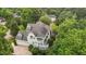 This large home features a stone chimney, screened porch, and lush landscaping at 4315 Sugar Pine Ln, Durham, NC 27705