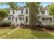 Back exterior of a white home featuring stone steps and a chimney at 4315 Sugar Pine Ln, Durham, NC 27705