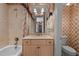 Bathroom featuring floral wallpaper, tub and shower, and vintage-style fixtures at 4315 Sugar Pine Ln, Durham, NC 27705