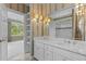 Bright bathroom featuring a marble vanity with double sinks and decorative wall sconces at 4315 Sugar Pine Ln, Durham, NC 27705