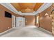 Large primary bedroom with decorative ceiling, television and access to en-suite and staircase at 4315 Sugar Pine Ln, Durham, NC 27705
