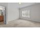 Bright bedroom with an ensuite bathroom and a large window with plantation shutters at 4315 Sugar Pine Ln, Durham, NC 27705