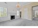 Open bedroom with a chandelier, fireplace and multiple windows offering great natural light at 4315 Sugar Pine Ln, Durham, NC 27705