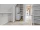 Utility closet featuring a stacked washer and dryer and built-in shelving at 4315 Sugar Pine Ln, Durham, NC 27705