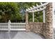 The outdoor deck features a pergola and stone wall, overlooking a beautiful backyard at 4315 Sugar Pine Ln, Durham, NC 27705