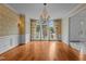 Dining room with hardwood floors, chandelier lighting, and large windows overlooking the yard at 4315 Sugar Pine Ln, Durham, NC 27705