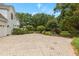 Driveway leading to a white house with mature trees and landscaped grounds at 4315 Sugar Pine Ln, Durham, NC 27705