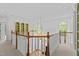 Foyer boasts open landing, arched windows, hardwood floors, and custom trim at 4315 Sugar Pine Ln, Durham, NC 27705