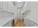 Bright laundry room with white cabinets, countertop space, and hardwood floors at 4315 Sugar Pine Ln, Durham, NC 27705