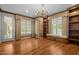 Living room with hardwood floors, built-in bookshelves, and plenty of natural light at 4315 Sugar Pine Ln, Durham, NC 27705
