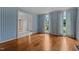 Living room with hardwood floors, patterned wallpaper, and views into foyer at 4315 Sugar Pine Ln, Durham, NC 27705