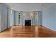 Bright living room with hardwood floors, fireplace, and diamond patterned wallpaper at 4315 Sugar Pine Ln, Durham, NC 27705