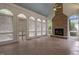 Light filled sunroom with a stone fireplace and multiple windows at 4315 Sugar Pine Ln, Durham, NC 27705