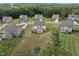 An aerial view of homes in a well-maintained neighborhood surrounded by lush green trees at 433 Village Bend Dr, Fuquay Varina, NC 27526