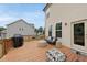A view of the wooden back deck furnished with trendy outdoor seating and a barbecue grill at 433 Village Bend Dr, Fuquay Varina, NC 27526