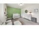 Bright Bedroom with crib, stylish dresser, olive accent wall, and ample natural light at 433 Village Bend Dr, Fuquay Varina, NC 27526