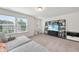 A bright bonus room with three windows, a large sofa, and a trendy entertainment center at 433 Village Bend Dr, Fuquay Varina, NC 27526