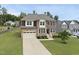 Beautiful two-story home featuring a manicured lawn and a large driveway leading to a two-car garage at 433 Village Bend Dr, Fuquay Varina, NC 27526