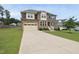 Two-story home with a stone and vinyl exterior, showcasing a spacious driveway and well-maintained lawn at 433 Village Bend Dr, Fuquay Varina, NC 27526