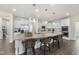 Spacious kitchen featuring a large island with bar seating and white cabinets at 433 Village Bend Dr, Fuquay Varina, NC 27526