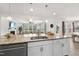Kitchen island with stainless steel sink, white cabinets, and open floor plan at 433 Village Bend Dr, Fuquay Varina, NC 27526